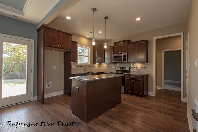 kitchen with appliances with stainless steel finishes, backsplash, a kitchen island, dark wood-style flooring, and dark brown cabinetry