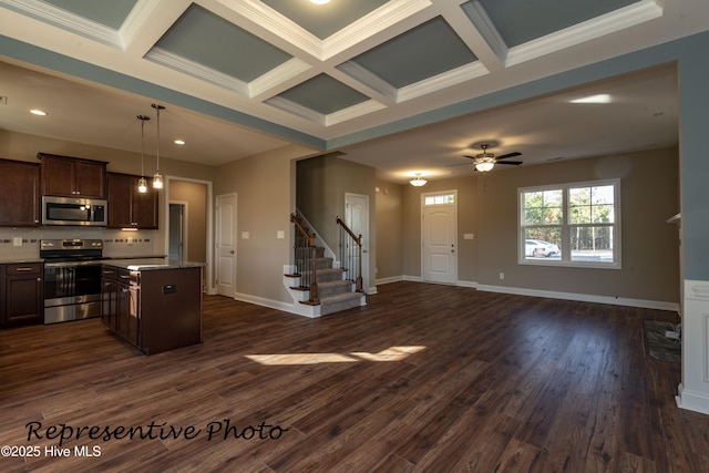 kitchen with stainless steel appliances, open floor plan, coffered ceiling, dark brown cabinetry, and a center island