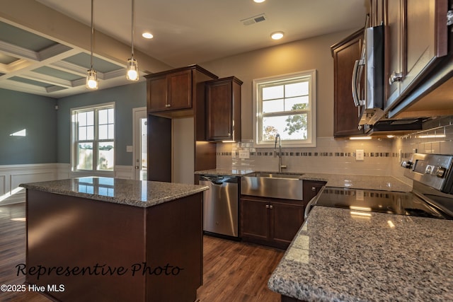 unfurnished living room with ceiling fan, coffered ceiling, a tile fireplace, stairs, and dark wood finished floors