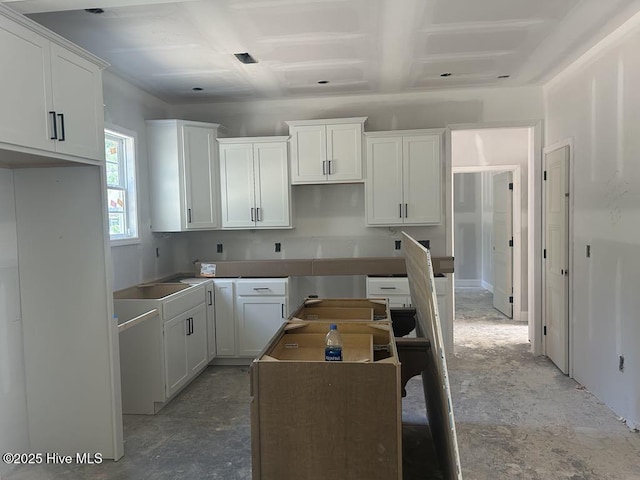unfurnished room featuring coffered ceiling and beam ceiling