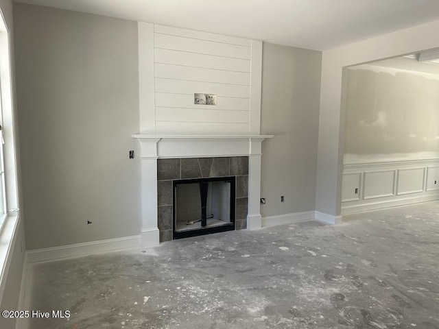 15661 Vista Point Ct, Wagram, NC 28396 - unfurnished living room with a fireplace, unfinished concrete floors, and baseboards