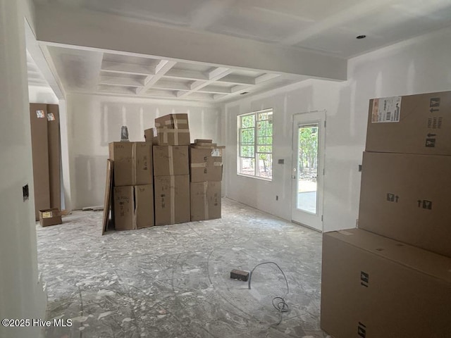 unfurnished living room with coffered ceiling and beamed ceiling