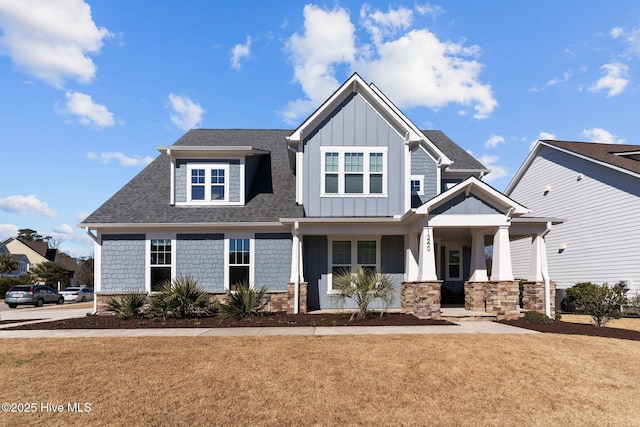 craftsman inspired home with a porch and a front lawn