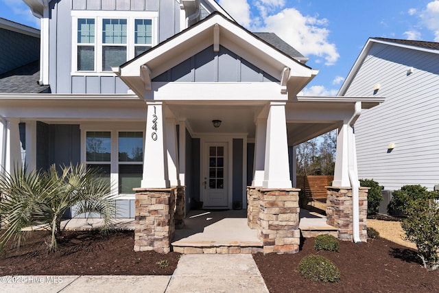 view of exterior entry featuring a porch