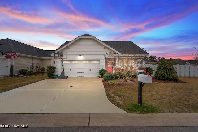 view of front of property with a yard and a garage