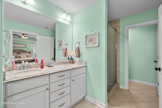 bathroom featuring tile patterned flooring, vanity, and walk in shower