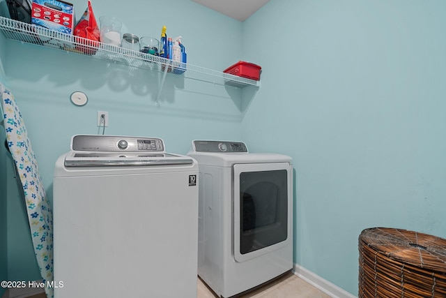 clothes washing area featuring washer and clothes dryer