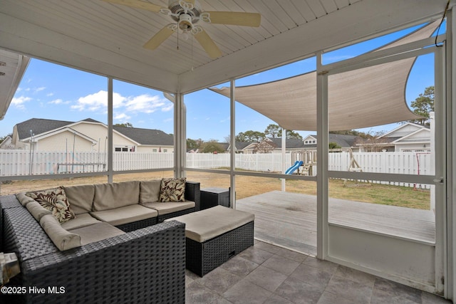 sunroom / solarium featuring ceiling fan