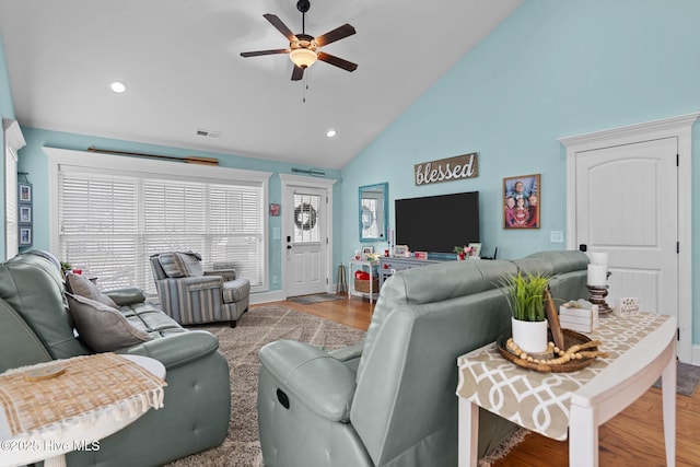 living room featuring hardwood / wood-style flooring, high vaulted ceiling, and ceiling fan