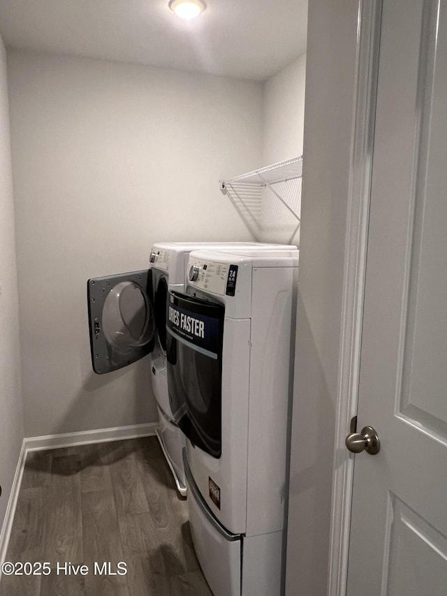 washroom featuring laundry area, dark wood finished floors, independent washer and dryer, and baseboards