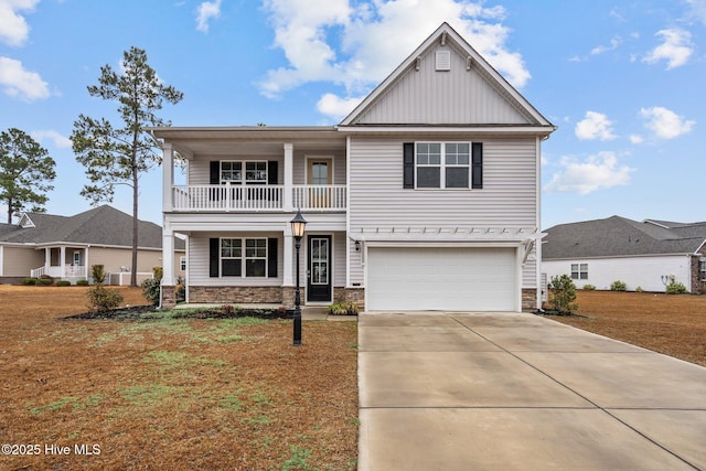 view of front of house featuring a balcony, a garage, and a front yard