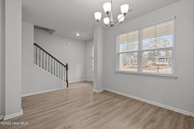 interior space featuring an inviting chandelier and light wood-type flooring