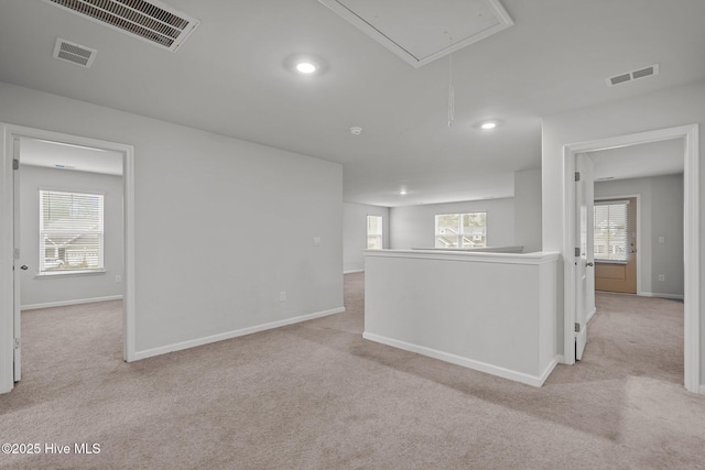 spare room with light carpet and a wealth of natural light