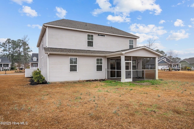 back of house featuring a patio, a sunroom, and a yard