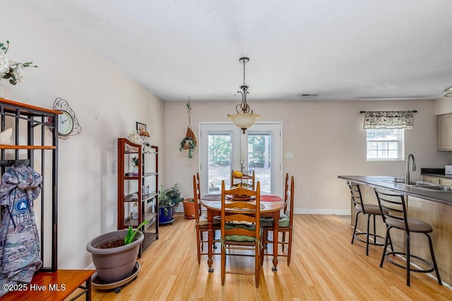 dining room with light wood-type flooring and baseboards