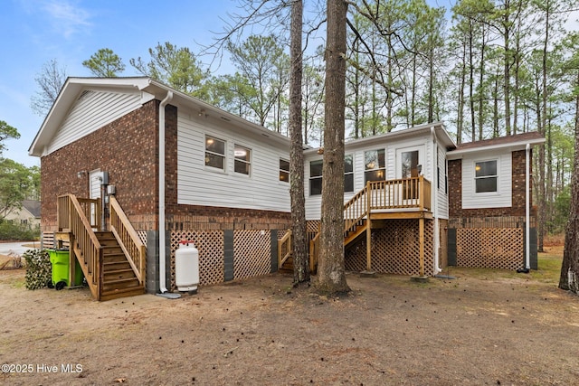 806 Wind Way, New Bern, NC 28560 - view of front facade with stairs, an attached garage, brick siding, covered porch, and driveway