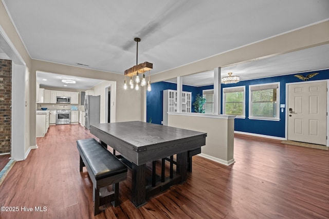 806 Wind Way, New Bern, NC 28560 - dining area with baseboards, visible vents, wood finished floors, and a chandelier