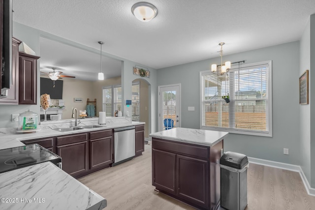 kitchen featuring sink, light hardwood / wood-style flooring, dishwasher, a kitchen island, and pendant lighting