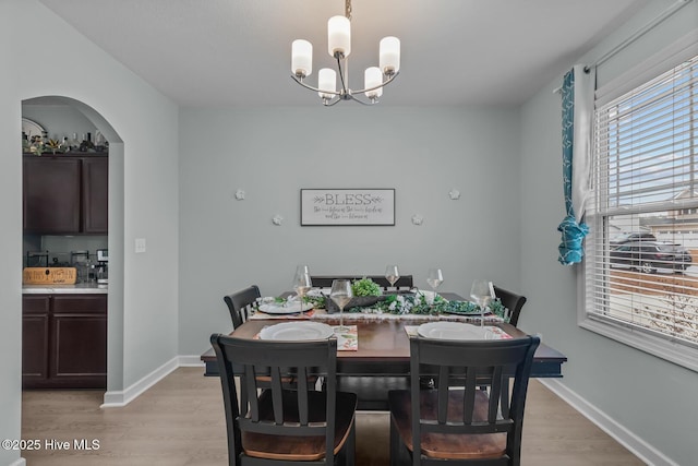 dining room featuring an inviting chandelier and light hardwood / wood-style floors