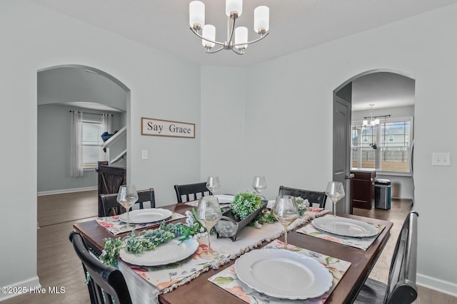 dining room featuring hardwood / wood-style flooring and a notable chandelier