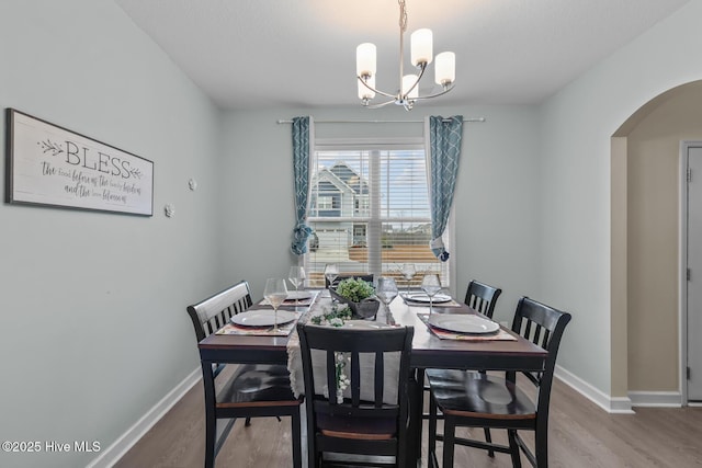 dining room featuring hardwood / wood-style flooring and a chandelier