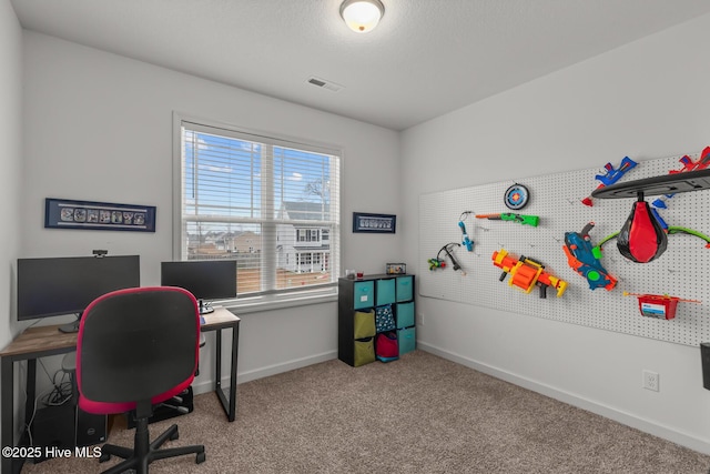 home office with light colored carpet and a textured ceiling