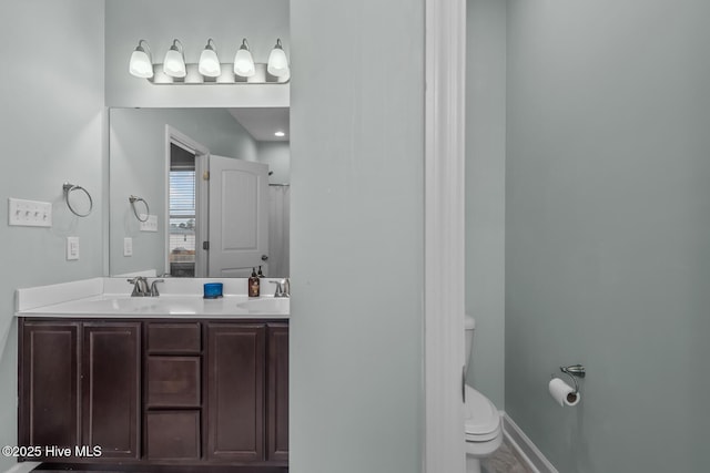 bathroom featuring vanity and toilet