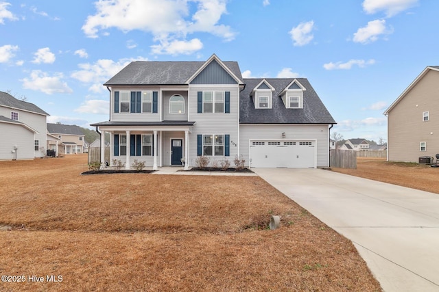 view of front of home with central AC, a porch, a garage, and a front yard