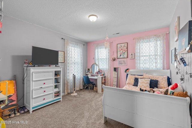 bedroom featuring carpet and a textured ceiling