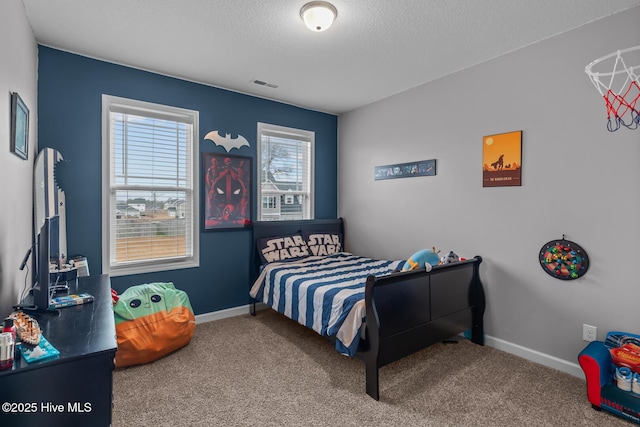 bedroom featuring carpet floors and a textured ceiling