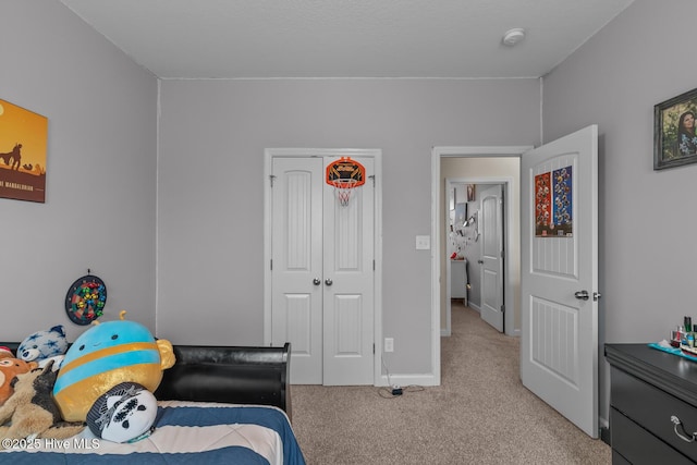 bedroom with a closet and light carpet