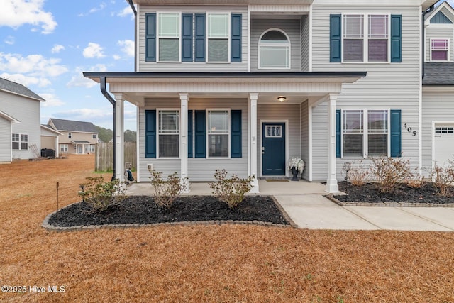 view of front facade with a front yard and covered porch