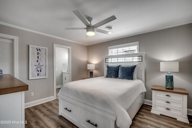 301 43rd Ave N, North Myrtle Beach, SC 29582 - bedroom with connected bathroom, crown molding, visible vents, baseboards, and wood finished floors