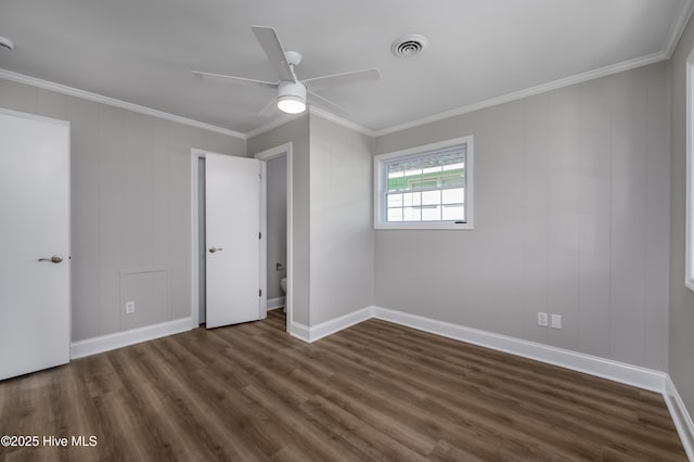 unfurnished bedroom with ornamental molding, dark hardwood / wood-style floors, and ceiling fan