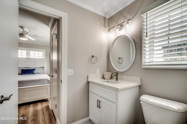 301 43rd Ave N, North Myrtle Beach, SC 29582 - bathroom with ornamental molding, vanity, a ceiling fan, and wood finished floors