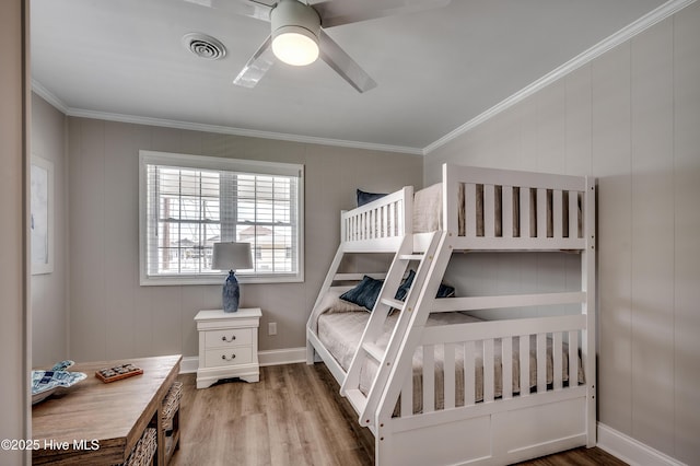 301 43rd Ave N, North Myrtle Beach, SC 29582 - bedroom with crown molding, visible vents, baseboards, wood finished floors, and a ceiling fan