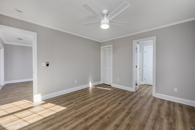 spare room featuring hardwood / wood-style floors, crown molding, and ceiling fan