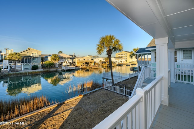 dock area featuring a balcony and a water view