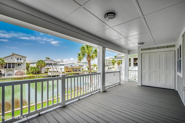 301 43rd Ave N, North Myrtle Beach, SC 29582 - wooden terrace featuring covered porch, a residential view, and a water view