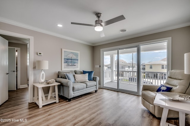301 43rd Ave N, North Myrtle Beach, SC 29582 - living area featuring visible vents, ornamental molding, ceiling fan, and light wood-style floors