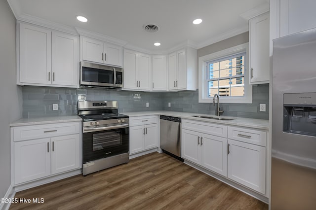 kitchen featuring white cabinetry, appliances with stainless steel finishes, and sink