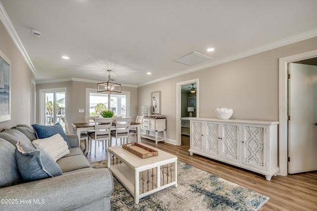 301 43rd Ave N, North Myrtle Beach, SC 29582 - living room with recessed lighting, a chandelier, crown molding, visible vents, and wood finished floors