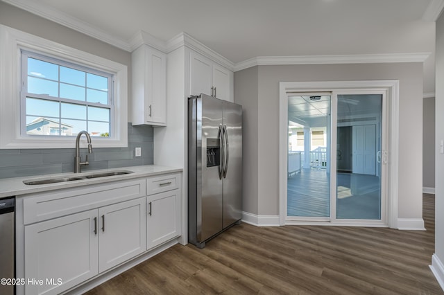 kitchen with crown molding, stainless steel appliances, sink, and white cabinets