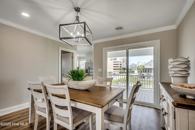 301 43rd Ave N, North Myrtle Beach, SC 29582 - dining area featuring an inviting chandelier, dark wood-style flooring, visible vents, and ornamental molding