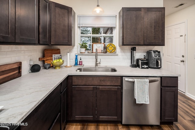 kitchen featuring dishwasher, dark wood-style flooring, light stone countertops, dark brown cabinets, and a sink