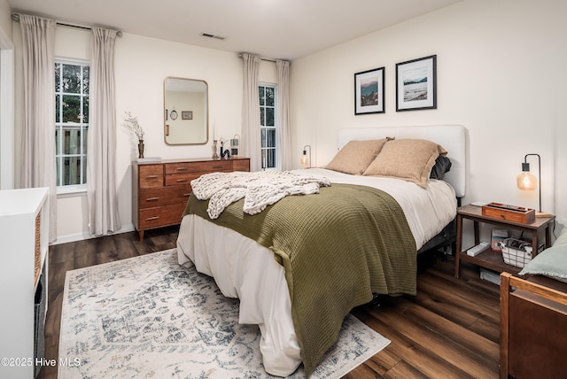 bedroom featuring dark wood-type flooring and visible vents