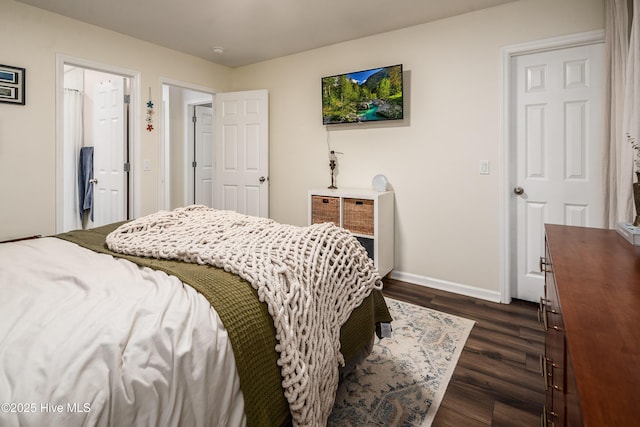 bedroom featuring dark wood-style flooring and baseboards