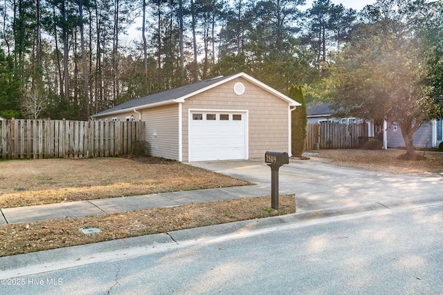 detached garage with driveway and fence