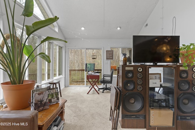 living room featuring a wealth of natural light, carpet floors, and vaulted ceiling