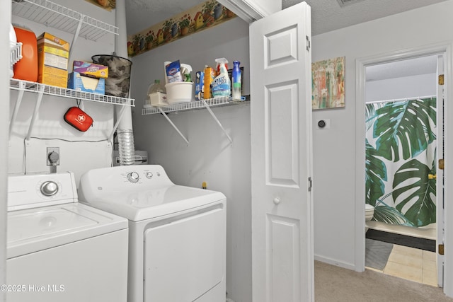 clothes washing area featuring light colored carpet and washing machine and dryer